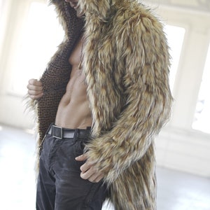 May include: A brown and black faux fur coat with a hood. The coat is open and the lining is visible. The lining is a brown and black geometric pattern.