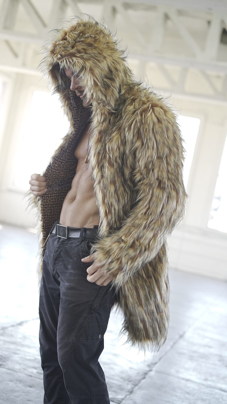 May include: A brown and black faux fur coat with a hood. The coat is open and the lining is visible. The lining is a brown and black geometric pattern.
