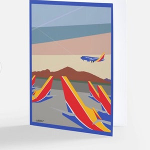 May include: Greeting card featuring a stylized illustration of a Southwest Airlines jet taking off over a desert landscape. The card has a blue border and depicts several red, yellow, and blue airplane tail fins.
