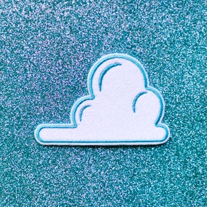 May include: White felt cloud patch with a light blue outline, on a sparkly turquoise background.