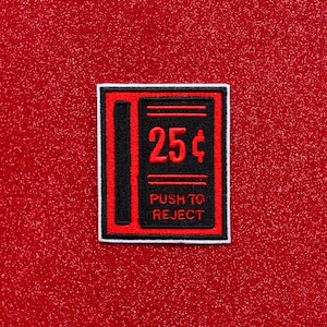 May include: Red and black embroidered patch with white trim. The patch features the text "25¢" and "PUSH TO REJECT".