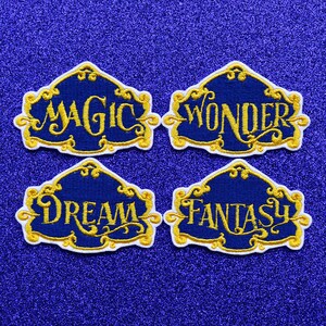 May include: Four embroidered patches with gold lettering on a blue background. The patches feature the words "Magic", "Wonder", "Dream", and "Fantasy".
