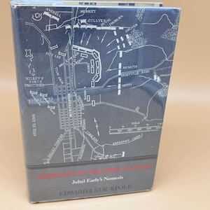 May include: A hardcover book titled Sheridan in the Shenandoah: Jubal Early's Nemesis by Edward J. Stackpole. The dark blue dust jacket features a white line-drawn military map of Winchester, Virginia, with various troop positions and labels.
