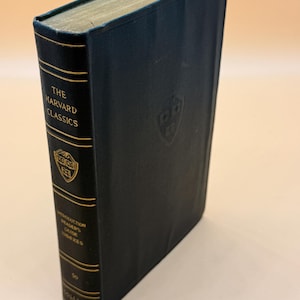 May include: A dark green hardcover book with gold lettering. The title is "The Harvard Classics" and the subtitle is "Introduction to the Reader's Guide to the Classics".