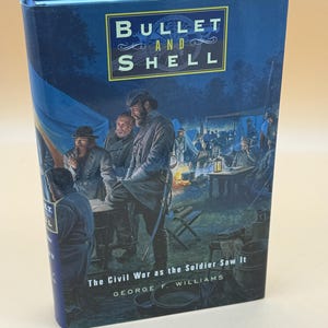 May include: A hardcover book titled Bullet and Shell: The Civil War as the Soldier Saw It by George F. Williams. The cover features a blue-toned illustration of soldiers in a camp setting with tents, a campfire, and figures in uniform.