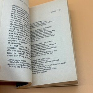 May include: An open book displaying text from Edgar Allan Poe's "Ligeia". The pages are off-white with black text. The book is open to pages 70 and 71, with the title "Ligeia" visible.