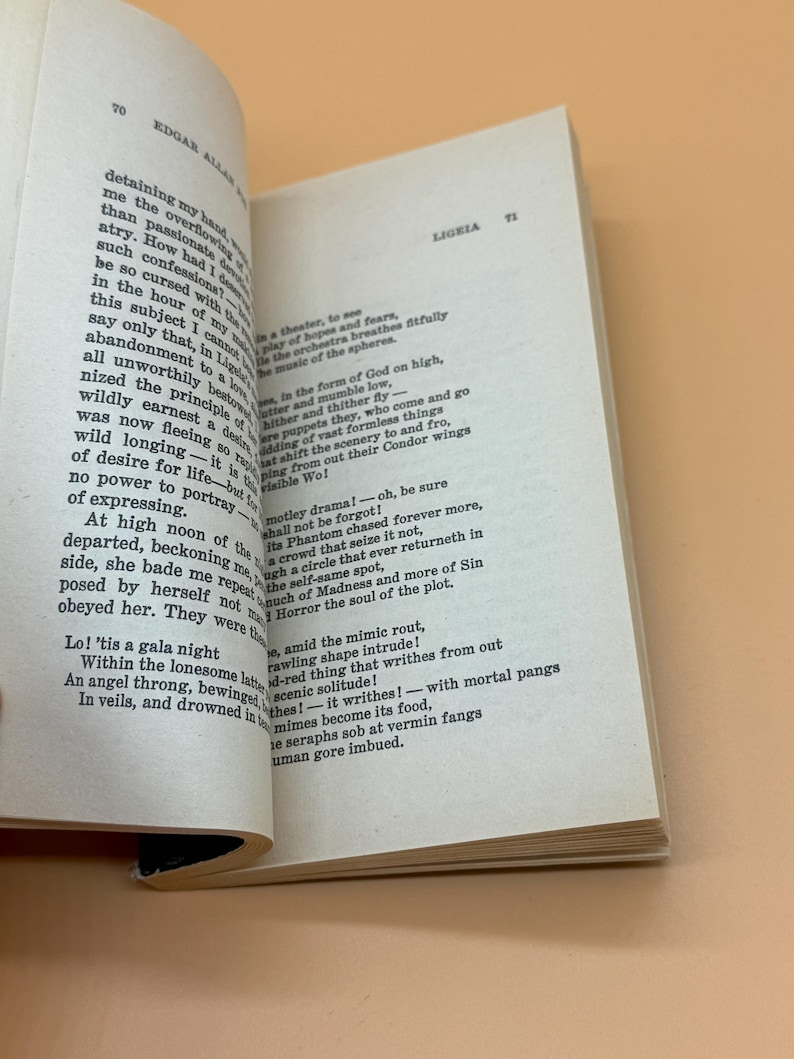 May include: An open book displaying text from Edgar Allan Poe's "Ligeia". The pages are off-white with black text. The book is open to pages 70 and 71, with the title "Ligeia" visible.