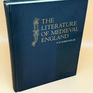 May include: A hardcover book titled "The Literature of Medieval England" by D.W. Robertson, Jr. The book has a dark blue cover with gold lettering and an ornate design. The book is slightly angled, showing the spine and the front cover.