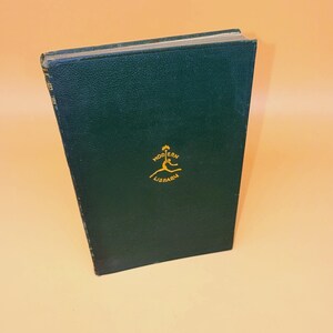 May include: A white ceramic mug with a black handle and the text "But First, Coffee" in a handwritten style. The mug is on a white surface. The mug is likely for hot beverages.