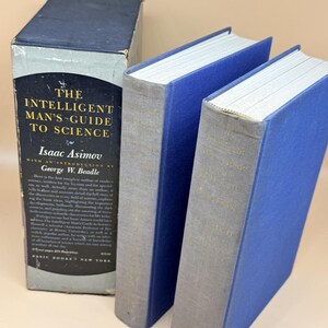 May include: A two-volume set of The Intelligent Man's Guide to Science by Isaac Asimov, featuring blue cloth-bound covers with grey spines. The set includes a black and light blue dust jacket with white and yellow text detailing the book's contents.