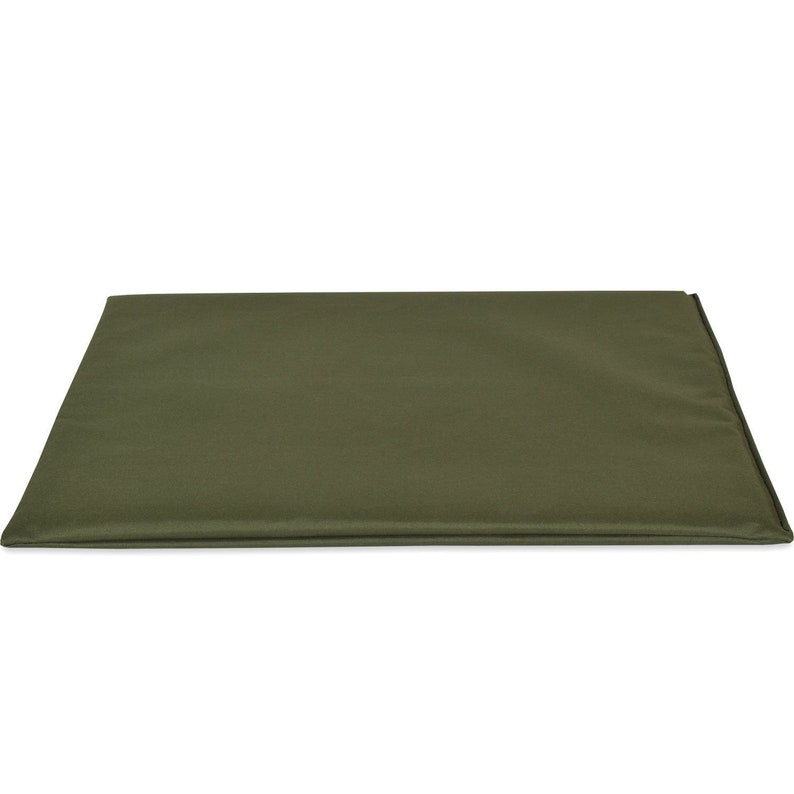 May include: An olive green rectangular pet bed, with a simple, minimalist design. The bed is made of a solid, textured fabric and is designed to provide a comfortable resting place for a pet. The bed is shown against a white background.