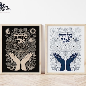 May include: Two framed prints with a floral design and the Hebrew words "Modeh Ani" meaning "I give thanks". The print on the left has a black background and beige floral design. The print on the right has a white background and blue floral design.