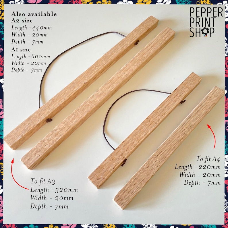May include: Two sets of light-colored wooden poster hangers with dark brown hanging cords. Text indicates A2 size is 440mm x 20mm x 7mm, A1 is 600mm x 20mm x 7mm, A3 is 320mm x 20mm x 7mm, and A4 is 220mm x 20mm x 7mm. Pepper Print Shop logo.