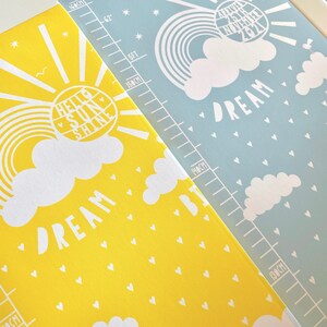Closeup of personalised Dream Big cloud height charts in yellow and blue