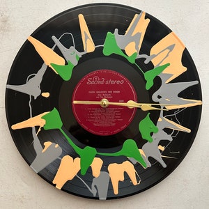 May include: A black vinyl record with a clock face painted in green, gray, and orange. The record is titled "Faith Unlocks The Door" by Jim Roberts and The Mellons. The record is a Sacred-stereo release.