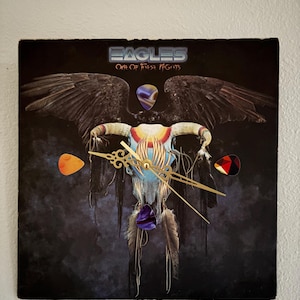 May include: A set of three ceramic mugs with a speckled, matte finish. The mugs are in shades of cream, light gray, and dark gray. Each mug has a simple, minimalist design and a rounded handle. Perfect for coffee or tea.