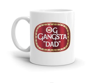 May include: White ceramic mug with a red and gold logo that says "OG Gangsta "Dad"".