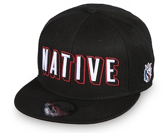 May include: Black baseball cap with a white "NATIVE" logo in a red outline. The cap has a black and white logo on the side.