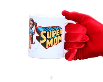 May include: White ceramic mug with a colorful illustration of a superhero woman and the text "SUPER MOM" in yellow and red letters.