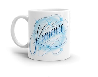 May include: White ceramic mug with a blue and white design featuring the name "Leanna" in a stylized script with sparkling stars.
