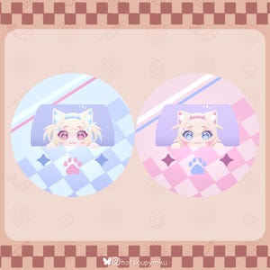 Op de afbeelding: Twee cirkelvormige illustraties van een stripfiguur met kattenoren, die onder een kussen vandaan piekt. De ene is blauw en wit, de andere roze en wit. Elk heeft een voetafdruk en sterren.