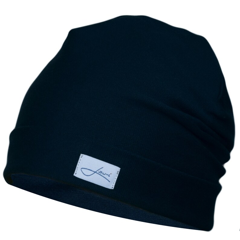 May include: A dark blue beanie with a small white label that says "Jumi" on it.