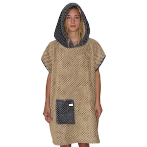 May include: A hooded towel poncho with a beige and blue patterned design. The poncho has a pocket on the front and a hood with a drawstring.