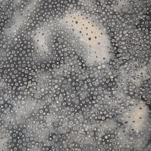 May include: A fabric featuring a speckled design. The base colour is dark grey, with lighter grey and white spots distributed across the material. The spots are of varying sizes and shapes, giving a textured look.