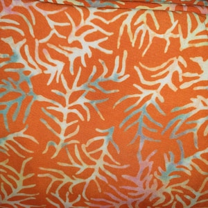 May include: A vibrant orange fabric featuring a repeating pattern of white, branching coral-like shapes. The design includes subtle, soft blue and light purple highlights integrated into the edges of the white organic, tree-like motifs.