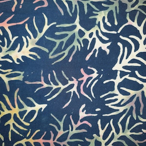 May include: A dark navy blue fabric featuring a repeating batik-style pattern of branching coral or seaweed shapes. The organic, tree-like forms are rendered in soft, blended gradients of pale yellow, light pink, and muted sage green colors.