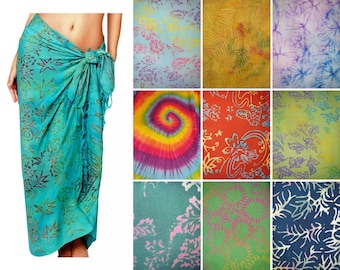 May include: A teal sarong with a dark leaf print tied at the waist, displayed alongside a grid of eight fabric swatches featuring various patterns including tie-dye, floral, and botanical designs in colors like yellow, red, green, and blue.