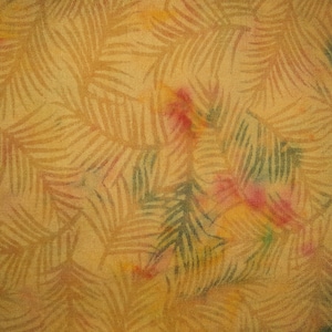 May include: A woven fabric featuring a repeating pattern of palm fronds in a muted golden yellow tone. The design is accented with soft, watercolor-style splashes of pink and green throughout the surface, creating a textured and layered appearance.