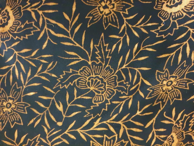 May include: A fabric featuring a dark navy blue background with a repeating pattern of golden yellow flowers and slender, pointed leaves. The floral design is rendered in thin, delicate lines that create a dense, continuous botanical motif.