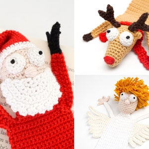 Pode incluir: Três marcadores de página de crochê com tema natalino: um Papai Noel com barba branca e terno vermelho, uma rena com chifres marrons e uma echarpe vermelha, e um anjo com asas brancas e cabelo loiro.