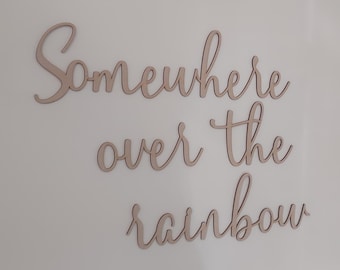 May include: Wooden wall decor with the phrase "Somewhere over the rainbow" in cursive script.