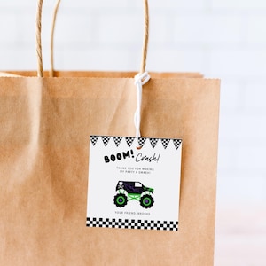 May include: A brown paper gift bag with a white string handle. A white tag with black and white checkered borders is attached to the bag. The tag has a green and black monster truck illustration and the text "BOOM! Crash! Thank you for making my party a smash! Your friend, Brooke."