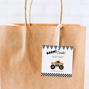 May include: A brown paper gift bag with a white string handle and a thank you tag attached. The tag has a black and white checkered border and says "BOOM! Crash! Thank you for making my party a smash! Your friend, Brooke" with a cartoon monster truck illustration.