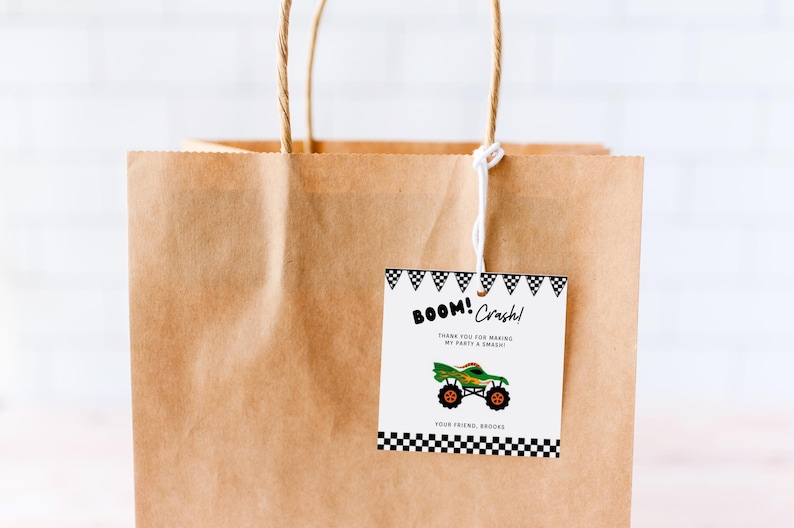 May include: A brown paper gift bag with a white string handle. A black and white tag with a monster truck graphic and the text "BOOM! Crash! Thank you for making my party a SMASH! Your friend, Brooke" is attached to the bag.