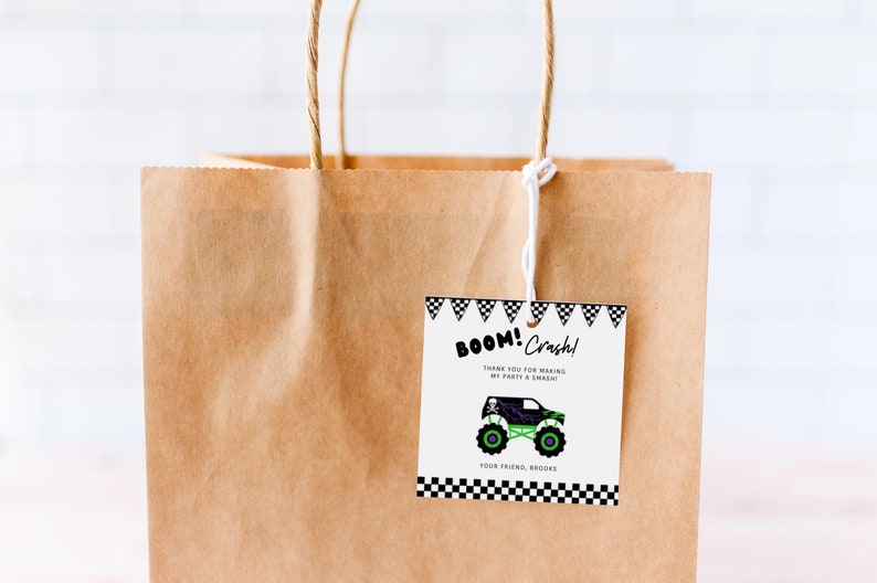May include: A brown paper gift bag with a white string handle. A white tag with black and white checkered borders is attached to the bag. The tag has a green and black monster truck illustration and the text "BOOM! Crash! Thank you for making my party a smash! Your friend, Brooke."