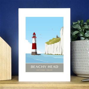 May include: An illustration of Beachy Head, a famous landmark in East Sussex, England. The illustration features a red and white lighthouse, white cliffs, and a blue sea.