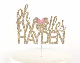 May include: Gold glitter cake topper with the text "Oh Two Dalles Hayden" and a pink Minnie Mouse head.