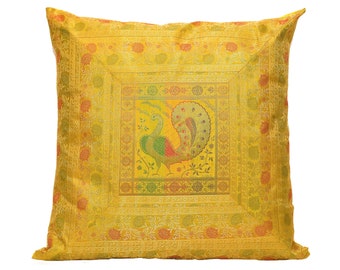 May include: A yellow throw pillow with a gold embroidered peacock design. The peacock is surrounded by a decorative border.
