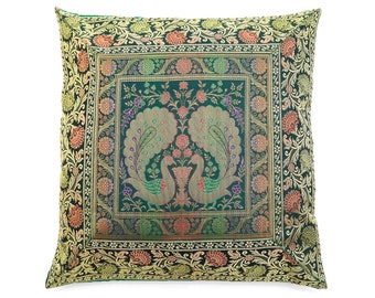 May include: A green square throw pillow with a gold and red embroidered design featuring two peacocks. The pillow has a border of floral and paisley patterns.
