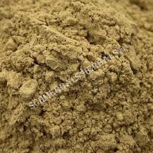 May include: Close-up of a pile of light brown powder. The powder is finely ground and has a slightly rough texture. The text "SCHIMMERBALSHERBALS" is visible in the image.