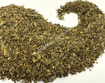 May include: A close-up of a pile of dried green mint leaves. The leaves are loose and have a slightly brown hue.