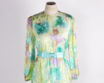 May include: A light green, yellow and purple floral print dress with a ruffled skirt and a matching satin sash.