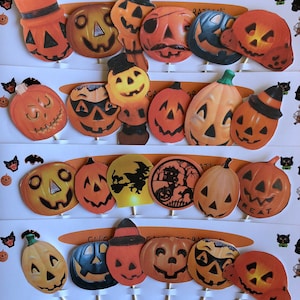 May include: A set of 20 Halloween cupcake toppers featuring various jack-o'-lantern designs. The toppers are printed on cardstock and have a stick attached to the back. The designs include traditional jack-o'-lanterns with different facial expressions, as well as some with hats, witches, and other Halloween themes.