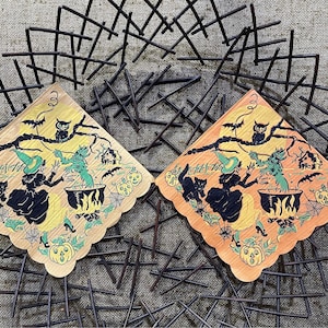 May include: Two vintage Halloween paper napkins with a witch, black cat, owl, and cauldron. The napkins are orange and yellow with a scalloped edge.