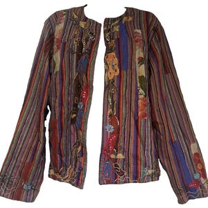 May include: A long-sleeved jacket featuring a vertical striped pattern in shades of purple, red, blue, and brown. The front panels are decorated with intricate floral embroidery, colorful fabric patches, and small sequins along the edges.