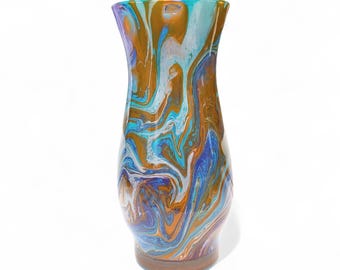 May include: A tall, decorative vase with a swirling pattern of colors including blue, orange, and white. The vase has a flared top and a rounded base. The overall height is approximately 10 inches.